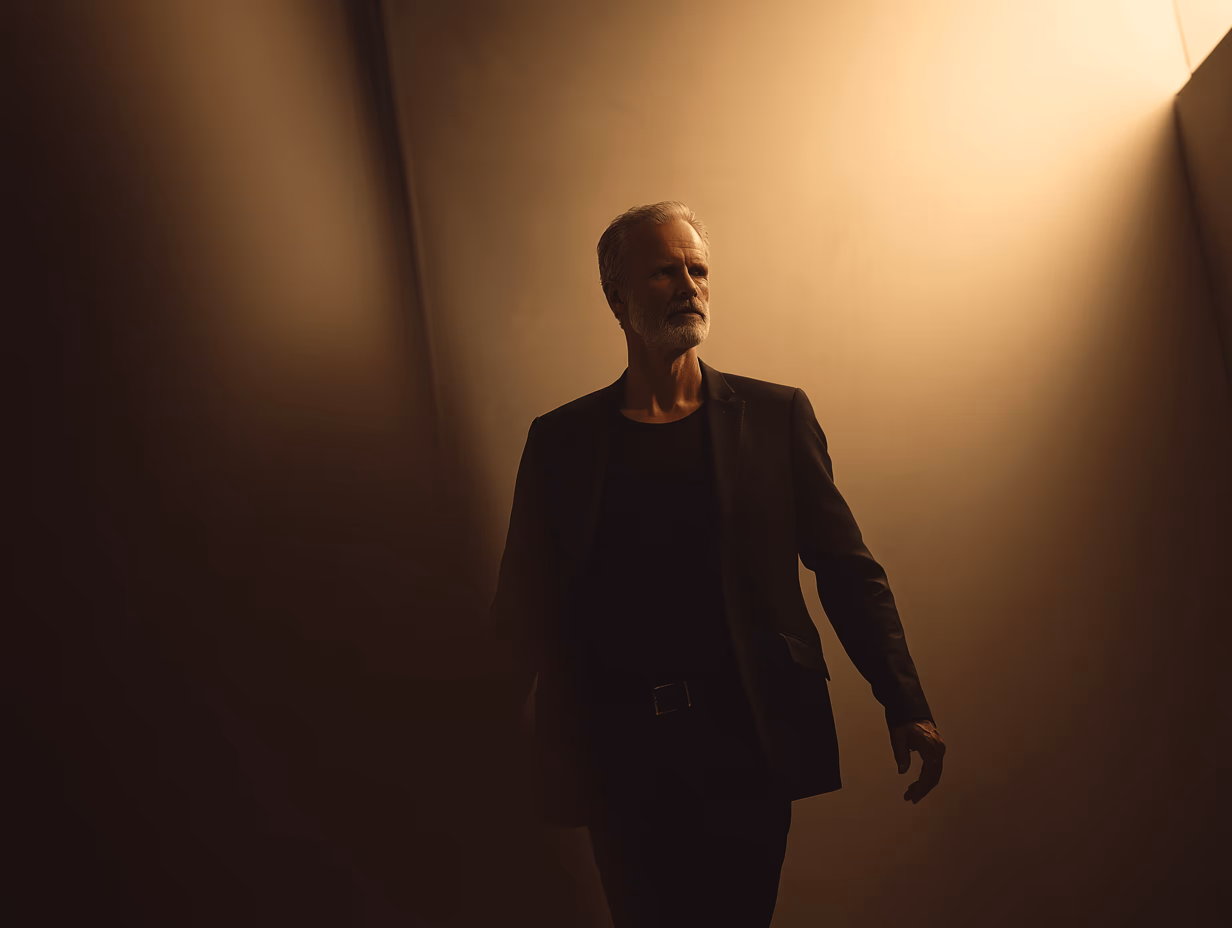 Silhouette of a man in warm side light.