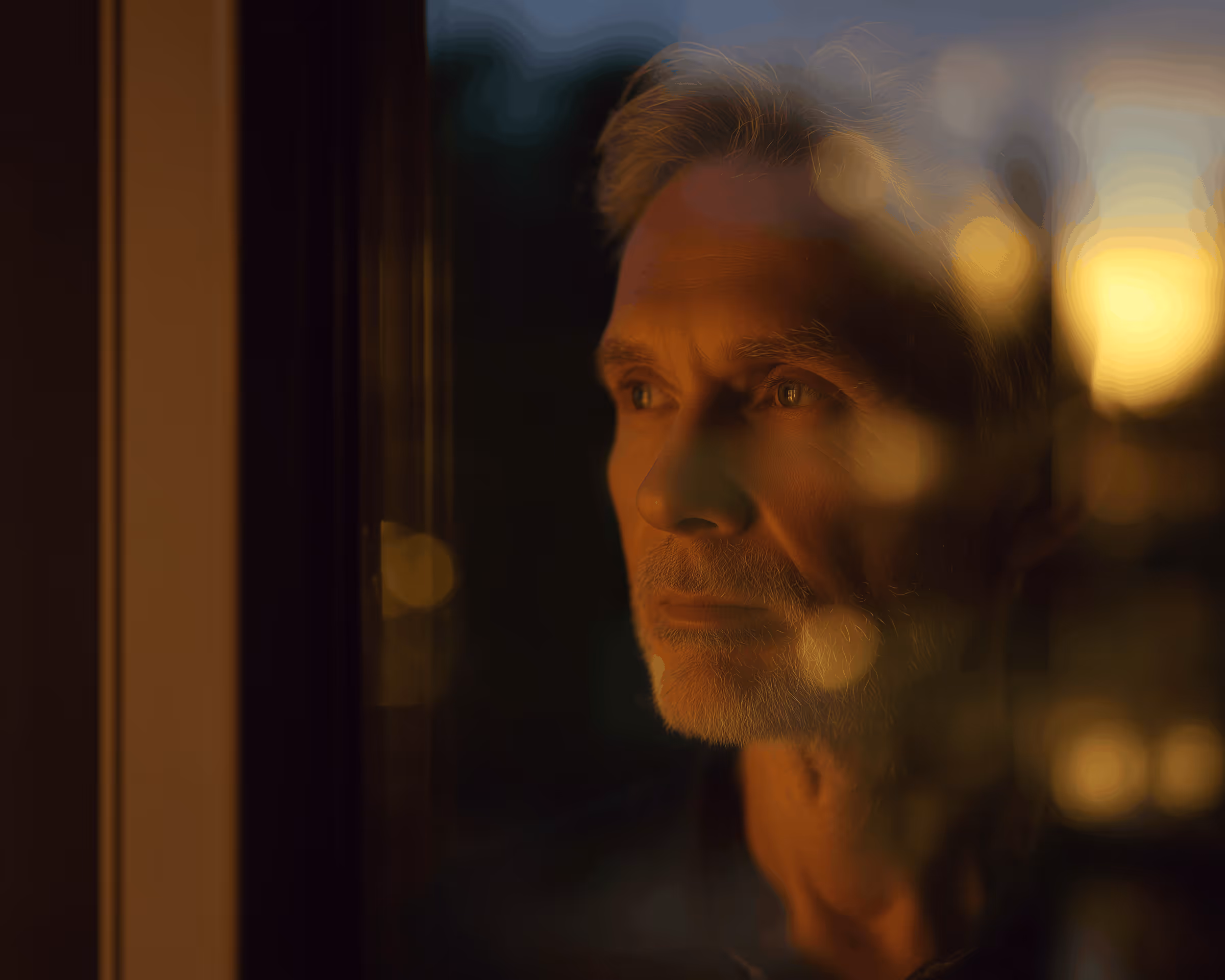 Warm portrait of a man in reflective evening light.